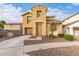 Two-story house with tan exterior, attached garage, and landscaped front yard at 5230 W Odeum Ln, Phoenix, AZ 85043