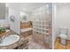 Bathroom with double sinks, a soaking tub, and a glass block shower at 5524 N 3Rd Ave, Phoenix, AZ 85013