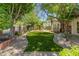 Landscaped front yard with artificial turf and a brick pathway at 5524 N 3Rd Ave, Phoenix, AZ 85013
