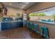 Indoor bar with brick wall, TV, and beverage fridge at 5524 N 3Rd Ave, Phoenix, AZ 85013