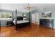 Main bedroom with hardwood floors, king-size bed, and a dresser at 5524 N 3Rd Ave, Phoenix, AZ 85013