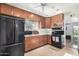 Kitchen with wood cabinets and black appliances at 6214 N 10Th St, Phoenix, AZ 85014