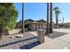 Ranch house with a large driveway and palm trees at 7615 N 46Th Ave, Glendale, AZ 85301