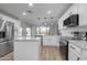 Modern kitchen with white cabinets, granite counters, and stainless steel appliances at 8244 W Willow Ave, Peoria, AZ 85381