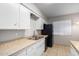 Kitchen features white cabinets and modern appliances at 843 N Cheri Lynn Dr, Chandler, AZ 85225