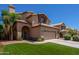 Two-story house with tan exterior, tile roof, landscaping, and a two-car garage at 1206 E Villa Rita Dr, Phoenix, AZ 85022