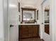 Elegant bathroom with dark wood vanity, a large mirror, and tile flooring at 12742 W Ash St, El Mirage, AZ 85335