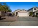 Cute one-story house with a pink garage door and well-maintained landscaping at 12742 W Ash St, El Mirage, AZ 85335