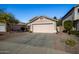 One-story house with a pink garage door, nicely landscaped front yard at 12742 W Ash St, El Mirage, AZ 85335