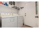 Laundry room with washer, dryer, and shelving for storage at 12742 W Ash St, El Mirage, AZ 85335