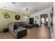 Comfortable living room featuring an L-shaped sectional and tile flooring at 12742 W Ash St, El Mirage, AZ 85335