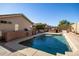 Large rectangular pool with surrounding patio and outdoor kitchen at 12742 W Ash St, El Mirage, AZ 85335