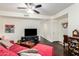 Living room with red sectional sofa, dark wood floors and entryway at 1633 E Lakeside Dr # 77, Gilbert, AZ 85234