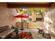 Cozy patio with seating area, red umbrella, and small garden at 1633 E Lakeside Dr # 77, Gilbert, AZ 85234