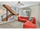 Living room with red sectional sofa and modern staircase at 2315 E Pinchot Ave # 105, Phoenix, AZ 85016