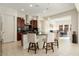 Modern kitchen with dark wood cabinetry, granite countertops, and breakfast bar seating at 26553 W Vista North Dr, Buckeye, AZ 85396