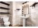 Stylish bathroom with pedestal sink and floating shelves at 31521 N 48Th St, Cave Creek, AZ 85331