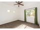 Well-lit bedroom with green curtains, ceiling fan and neutral carpeting at 31521 N 48Th St, Cave Creek, AZ 85331