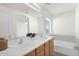 Double vanity bathroom with a large mirror and a bathtub at 38290 N Sandy Dr, San Tan Valley, AZ 85140