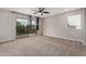 Bedroom with private balcony access and ceiling fan at 398 W Lyle Ave, San Tan Valley, AZ 85140