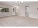 Spacious dining room with neutral walls, carpeting, and a chandelier at 398 W Lyle Ave, San Tan Valley, AZ 85140