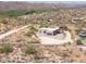 Aerial view of a house on a desert lot with views of mountains at 44635 San Domingo Peak Trl, Morristown, AZ 85342