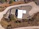 Bird's-eye view of a house with a gravel driveway and desert landscape at 44635 San Domingo Peak Trl, Morristown, AZ 85342