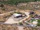 Aerial view of a house with a gravel driveway and desert landscape at 44635 San Domingo Peak Trl, Morristown, AZ 85342