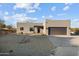 Single-story home with stucco exterior, dark brown garage door, and gravel landscaping at 44635 San Domingo Peak Trl, Morristown, AZ 85342