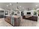 Modern kitchen with granite countertops and rustic wooden cabinets at 44635 San Domingo Peak Trl, Morristown, AZ 85342