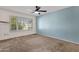 Bright bedroom features large window with shutters and ceiling fan at 4798 E Kiva St, Phoenix, AZ 85044