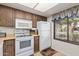 Bright kitchen features white appliances and wood cabinets at 543 S Desert Flower Dr, Mesa, AZ 85208