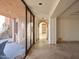 Elegant hallway with tile flooring and views to a patio and garden at 6020 E Indian Bend Rd, Paradise Valley, AZ 85253