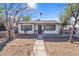 White single story home with walkway, landscaping, and a carport at 6107 W Orangewood Ave, Glendale, AZ 85301