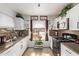 Modern kitchen with white cabinets and stainless steel appliances at 6428 W Townley Ave, Glendale, AZ 85302