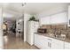 White kitchen cabinets, stainless steel appliances, view of dining area at 6428 W Townley Ave, Glendale, AZ 85302