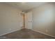 Spacious bedroom with carpet flooring and an adjacent bathroom at 7118 E Arbor Ave, Mesa, AZ 85208