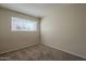 Well-lit bedroom featuring carpet flooring and a window with blinds at 7118 E Arbor Ave, Mesa, AZ 85208