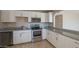 Kitchen with stainless steel appliances and white cabinets at 7118 E Arbor Ave, Mesa, AZ 85208