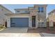 Two-story home with stone accents and a gray garage door at 10331 W Adam Ave, Peoria, AZ 85382