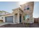 Two-story home with stone accents and a gray garage door at 10331 W Adam Ave, Peoria, AZ 85382