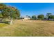 Expansive backyard showcasing a large lawn and lush greenery at 10610 W Saratoga Cir, Sun City, AZ 85351