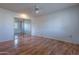 Bedroom featuring wood floors, mirrored closet doors, and ceiling fan at 10610 W Saratoga Cir, Sun City, AZ 85351