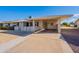 Front view of a single-story home with carport and well-maintained landscaping at 10610 W Saratoga Cir, Sun City, AZ 85351