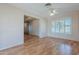 Simple office space with wood floors and access to other rooms at 10610 W Saratoga Cir, Sun City, AZ 85351