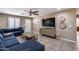 Living room with sectional sofa, TV, and wood media cabinet at 10638 N 15Th Ln, Phoenix, AZ 85029