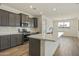 Modern kitchen with gray cabinets, quartz countertops, and stainless steel appliances at 12816 N 172Nd Dr, Surprise, AZ 85388