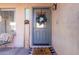 Inviting front door entrance with a festive wreath and welcome sign at 13928 N 145Th Ln, Surprise, AZ 85379