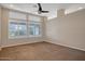 Well-lit bedroom with carpeted floor and window shutters at 14129 W Sky Hawk Dr, Sun City West, AZ 85375