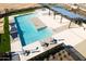 Community pool with a large deck and covered seating at 15664 W Winslow Ave, Goodyear, AZ 85338